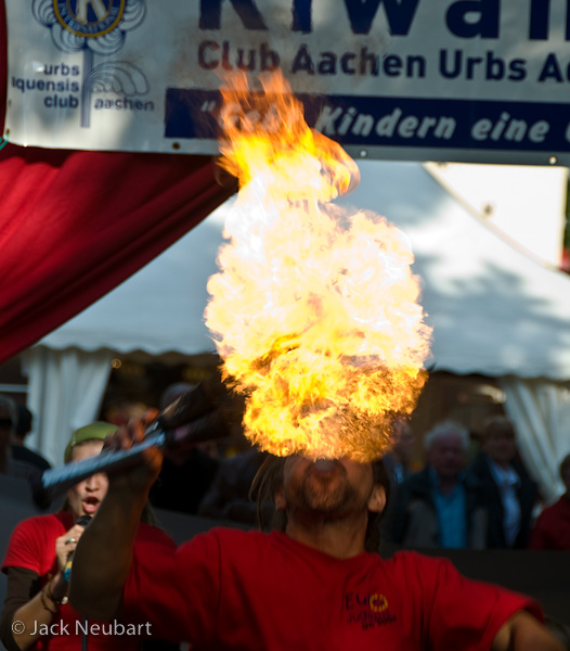 PEOPLE. I came upon this fire-eater at a festival in Aachen, Germany, quite by accident. Grabbing a spot in the crowd, I barely had time to zoom in (112mm/168mm equivalent) and frame the shot before this plume of flame erupted--and you could feel the searing heat from where I was standing.Photo Copyright  ©2009 Jack Neubart. All rights reserved.