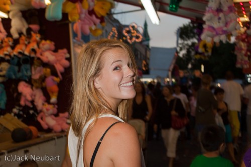 jn_t1i-07-abbyross Candid portrait. I met photographer Abby Ross at an Italian festival in my neighborhood. As she began to walk away, I yelled "smile," at which point she obligingly turned around. I snapped the shot without even looking through the finder, with the flash held a short distance from the camera. You can see this talented photographer's work at www.abbyross.com. Copyright ©2009 Jack Neubart. All rights reserved.