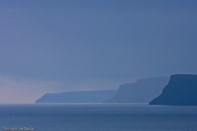 Midnight Dusk, LÃ¡trabjarg, Westfjords, Iceland. Effective focal length: 420mm.  The effect of miles of air is part of the flattening in this image.