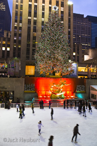 JN_10 (Christmas tree)  Rockefeller Center Christmas Tree. A Christmas in New York album would not be complete without a shot of the tree, the largest ever at Rockefeller Center. For this Manual exposure with the 17-55mm IS lens at 17mm, I used an exposure of f/4 and 1/15 sec, handholding the camera-image stabilization engaged. I had to boost highlight levels to bring up the tonality of the ice skating rink.  ©Jack Neubart. All rights reserved.