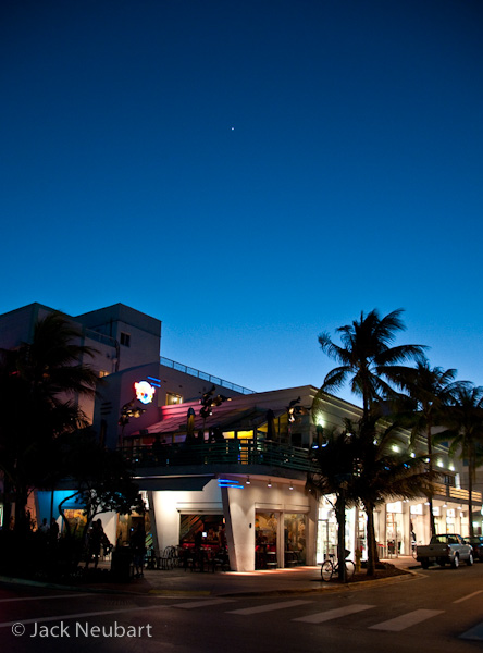 VIBRATION REDUCTION IN PRACTICE. In South Beach, FL, I set the lens at 18mm (= 27mm) for a 1/13 second exposure to capture this street at "Magic Hour" (ISO 800). A few minutes before that, with a little more light in the sky, I took a telephoto shot at 200mm (= 300mm) of a structure adorned with neon (ISO 400), surprising myself that this 1/15 second exposure came out reasonably sharp. Even with VR engaged, it's beneficial to observe proper camera handling technique to ensure sharp results: camera grasped firmly, eye to optical (not LCD) viewfinder, left hand supporting the lens and both feet planted squarely on the ground, a comfortable distance apart. Photos Copyright  ©2009 Jack Neubart. All rights reserved.