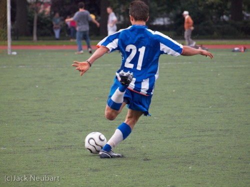 Soccer with the 40-150 zoom at a high ISO. With the 40-150 on the E-620 (zoomed out for this shot--full frame), I photographed several soccer matches in various AF modes. As they say, without a score card, hard to tell the players. In the final analysis, it wasn't AF that was the problem; it was shutter lag, which caused me to miss several key plays. Interestingly, Olympus has managed to deal successfully with noise even at ISO 3200 (although it is apparent at that stage--but not intolerable). I captured this play at ISO 800, with an f/5.6 exposure at 1/1000 sec (with an EV override of +2/3)--you might even be able to see sweat flying in the air. Copyright  ©2009 Jack Neubart. All rights reserved.