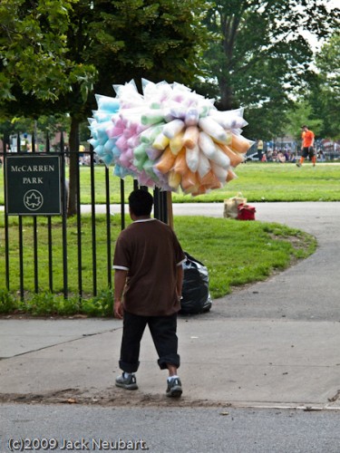 Shutter lag. This is an example of shutter lag in action. I had released the shutter just as the cotton candy vendor had moved into the right half of the frame, for a more interesting composition. By the time the camera responded, he'd taken a few steps, enough to practically put him center-frame and throw off my composition. Copyright  ©2009 Jack Neubart. All rights reserved.