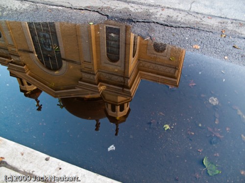 Reflections. Here I simply wanted to see if I could be more artistically expressive with the camera, by focusing on a reflection of the church in a pool of water by the curb. And at the same time, this also let me test image stabilization--unintentionally, I might add, since the camera was set to Program AE, delivering an 0.6 sec exposure at ISO 100, at the widest lens setting (effectively 28mm). However you do the math, not bad. Copyright  ©2009 Jack Neubart. All rights reserved.