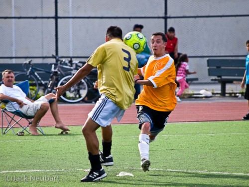 Capturing the moment. Here I shifted to Shutter Priority and 1/500 sec in an attempt to freeze action (at ISO 400--I didn't want to go higher). These shots capture tense moments of play focused around a ball seemingly suspended in midair, with just a touch of blur for realism. Copyright  ©2009 Jack Neubart. All rights reserved.