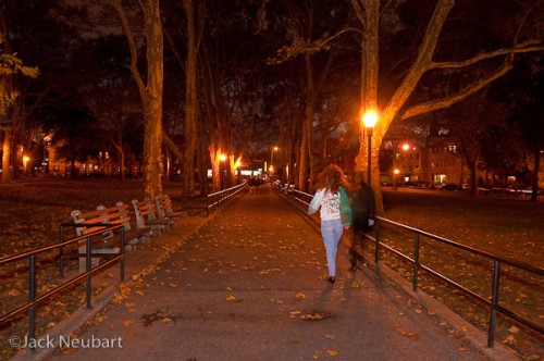 Park at Night. Here I set the camera to Program mode, letting the SB-900 fill in the foreground for this 1/2-second exposure. While it was after Halloween, I found it rather odd that I captured a ghostly figure walking toward the light (in the foreground). Spooky